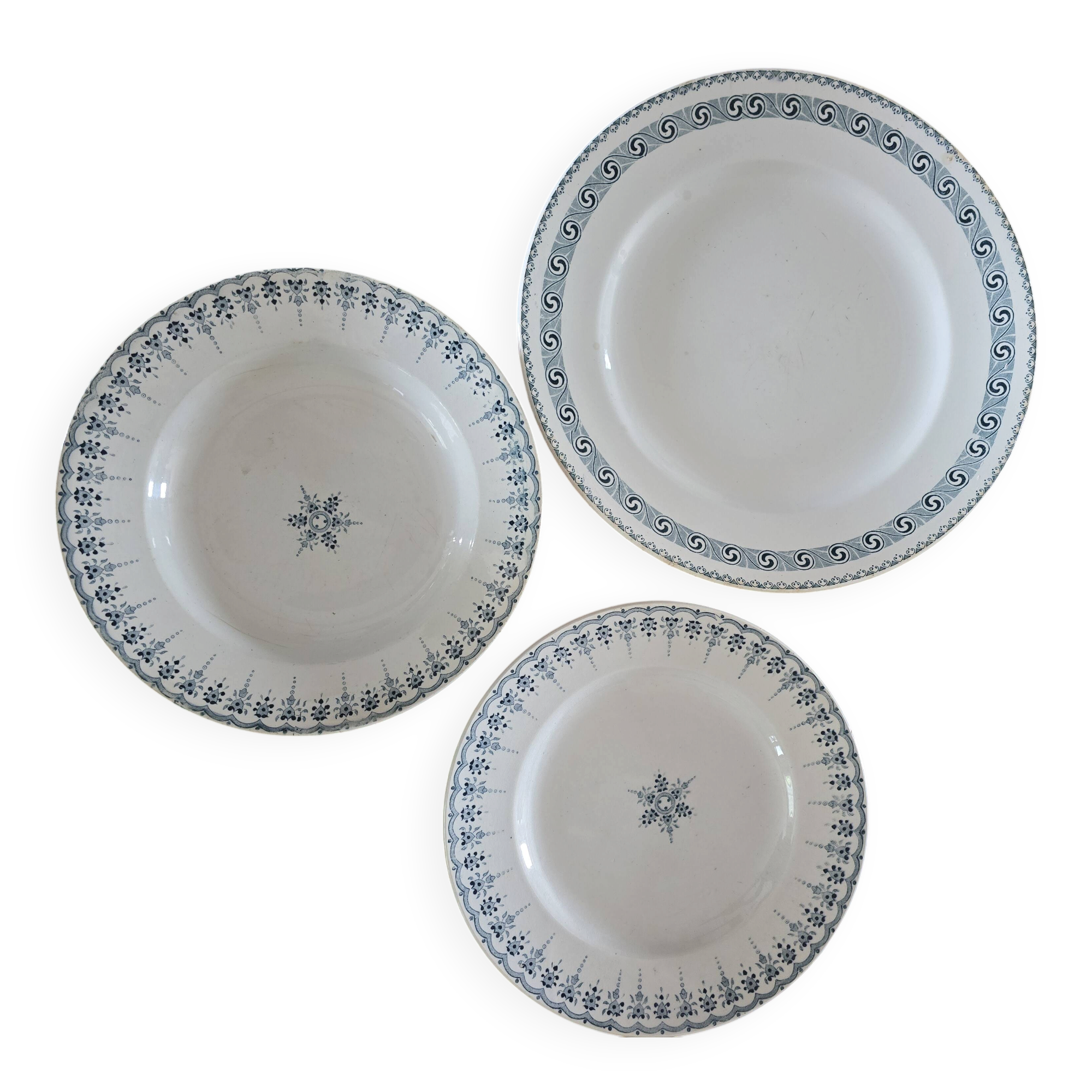 Old green-blue faience plates and dishes with geometric patterns.