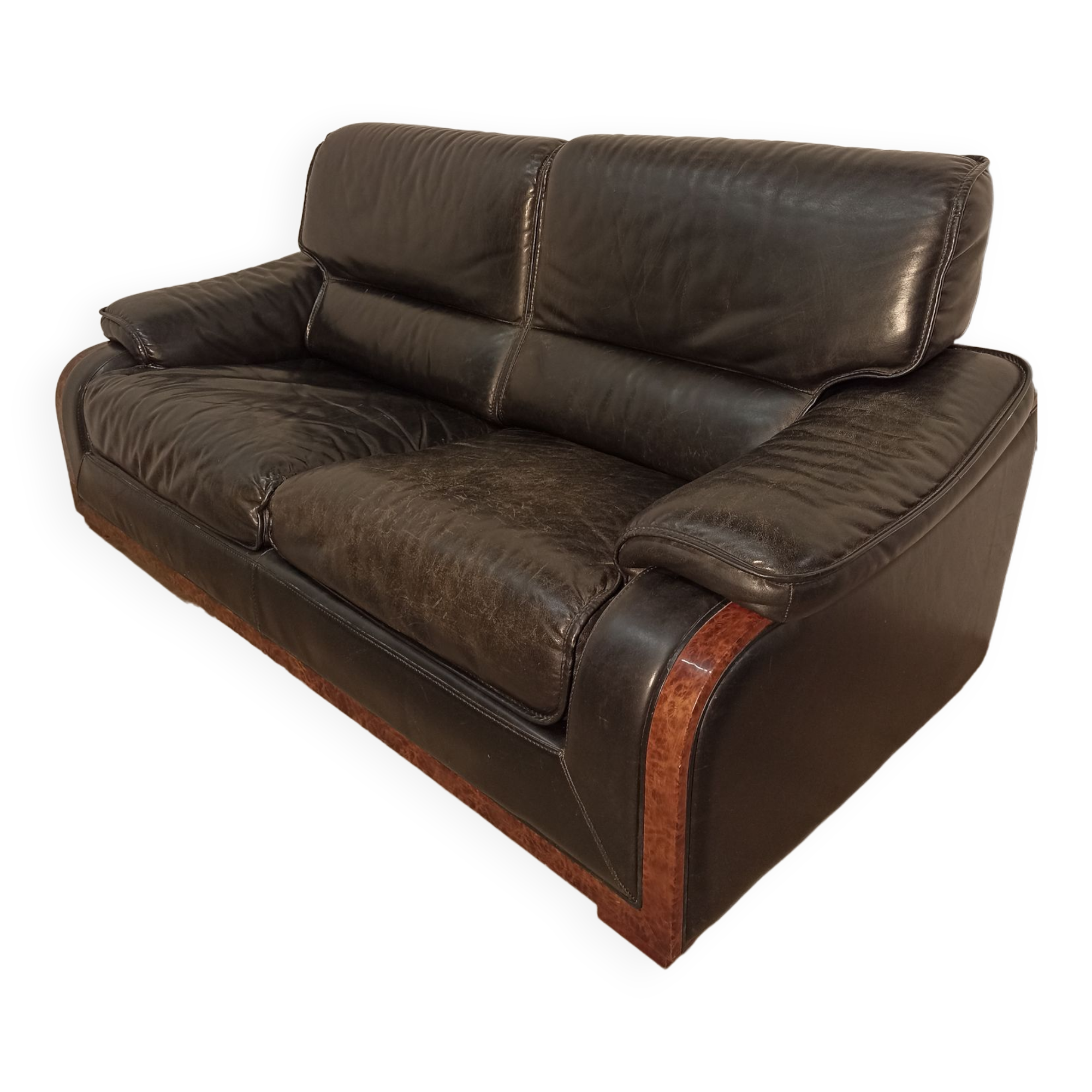 Black leather sofa and wooden armrests