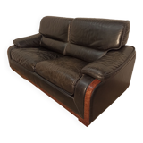 Black leather sofa and wooden armrests