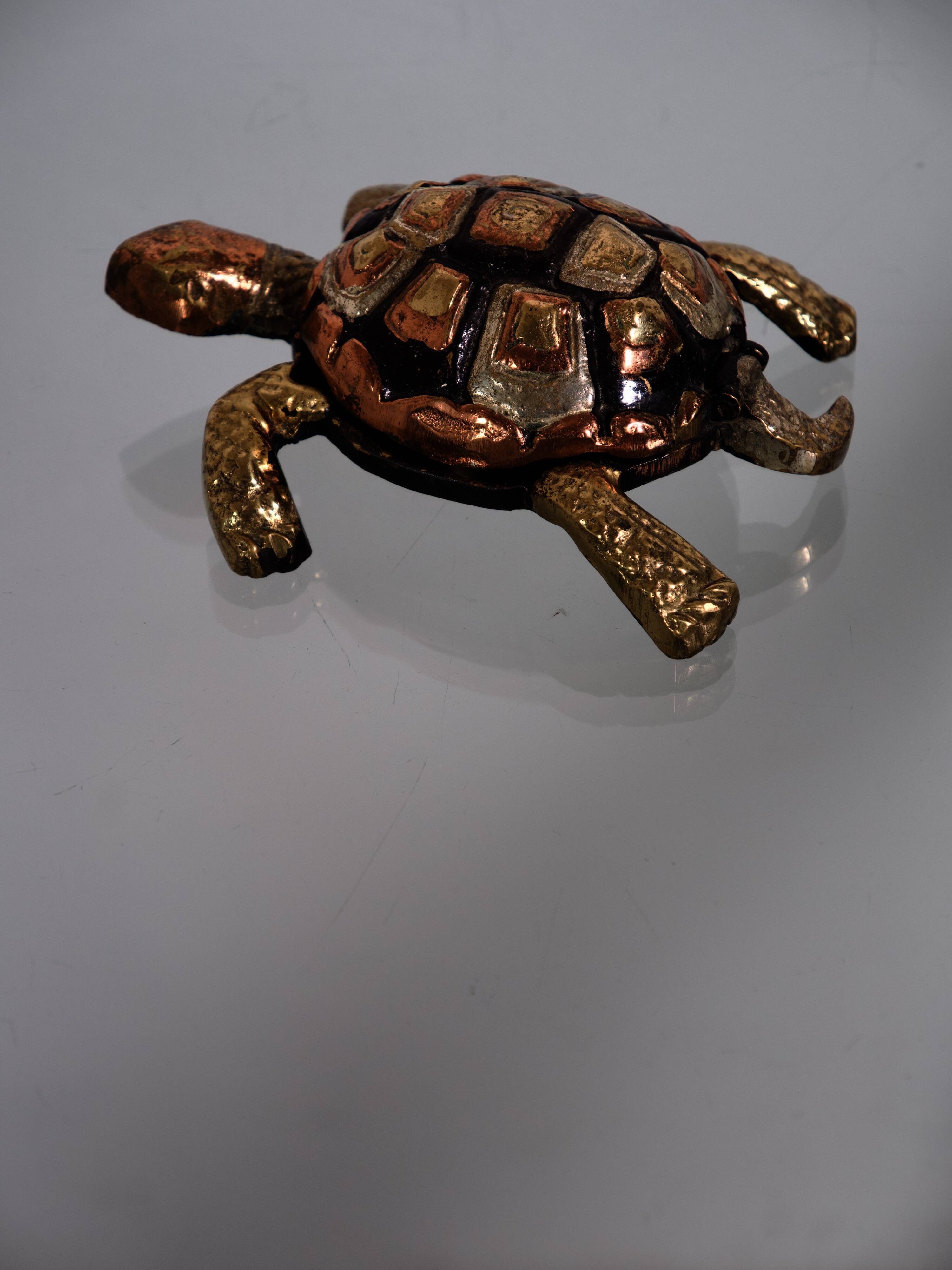 Golden brass turtle in decorative ashtray