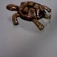 Golden brass turtle in decorative ashtray