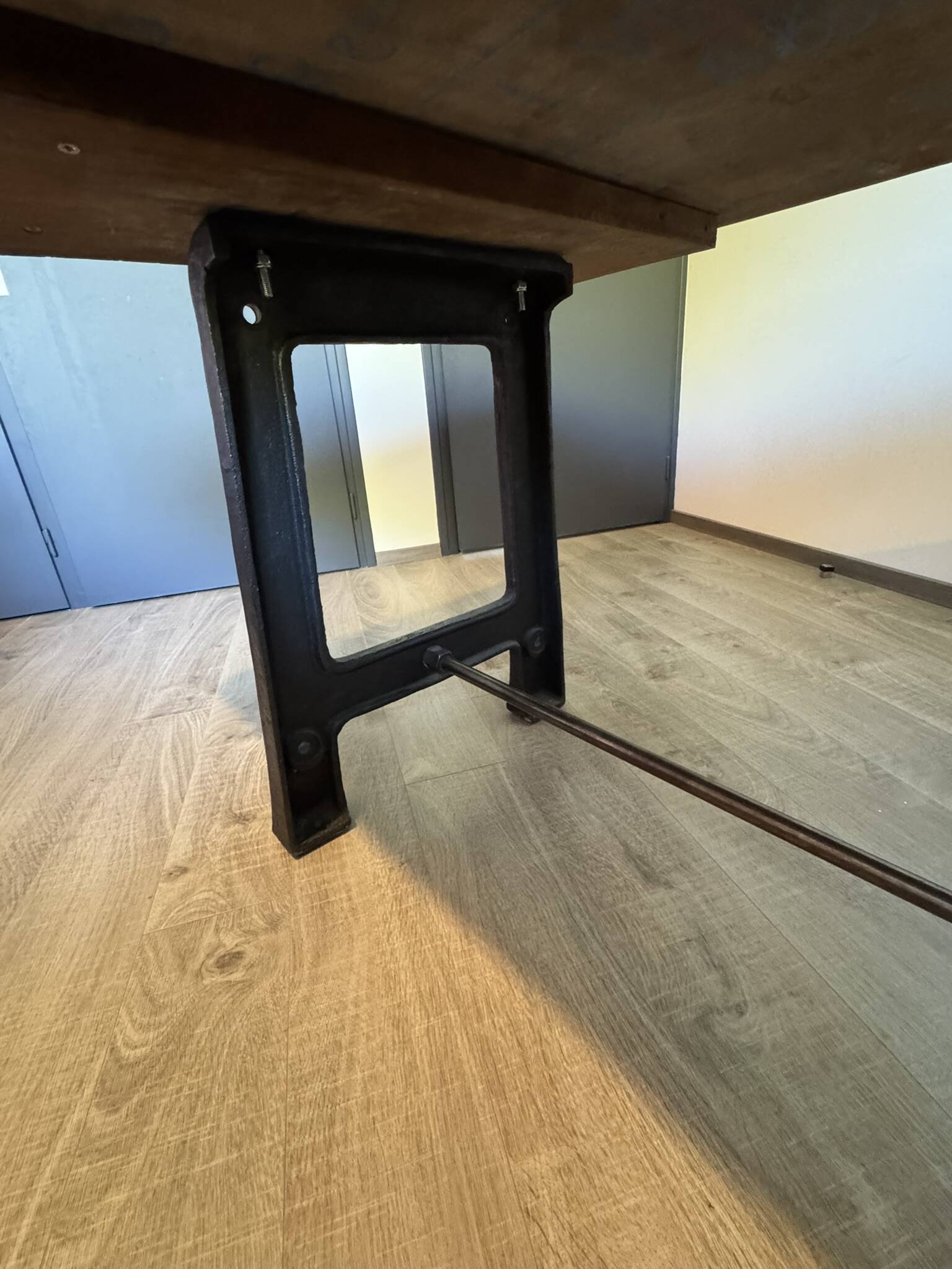 Industrial style table with a mahogany top.
