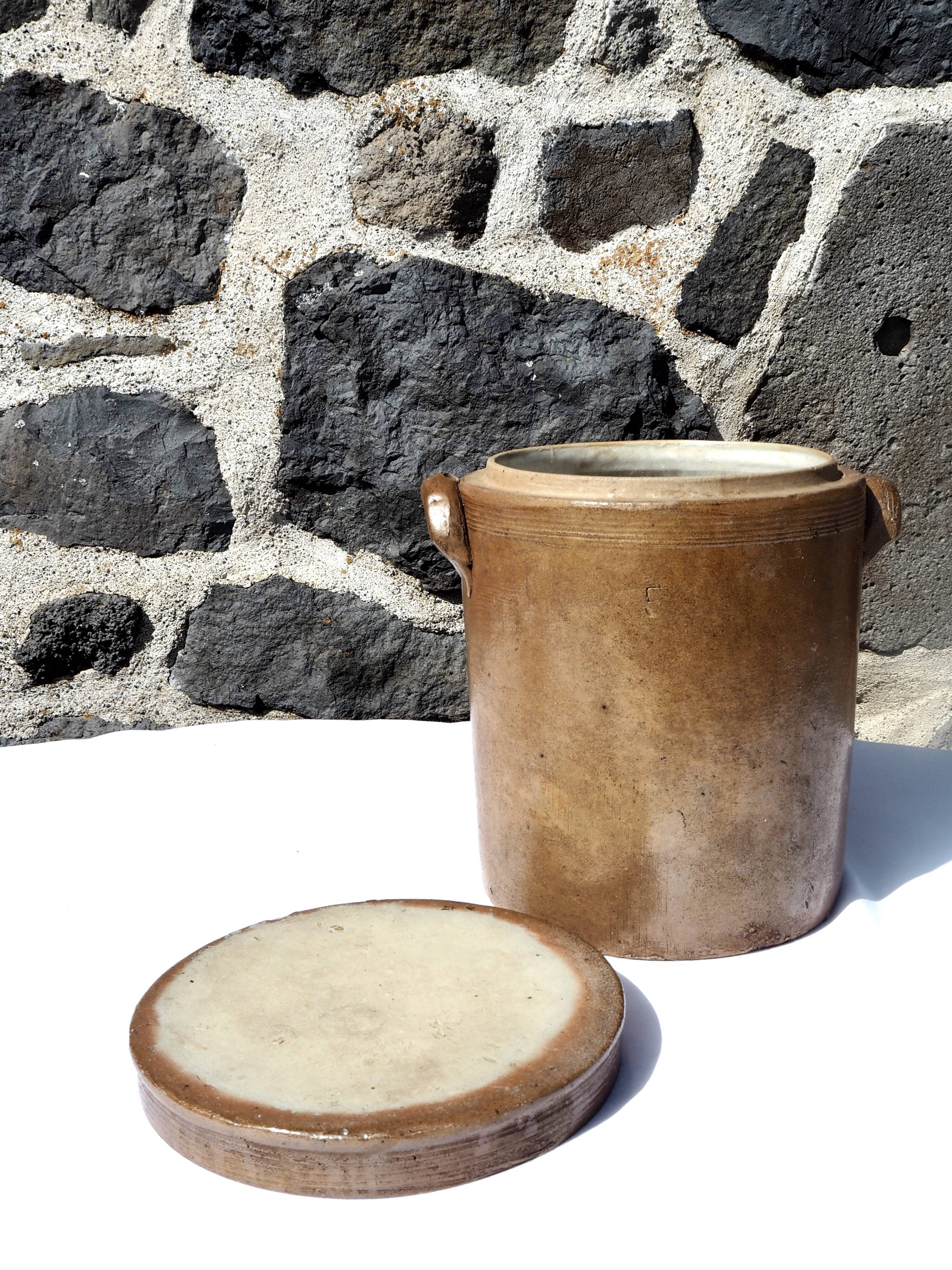 Trio of stoneware pots with lids