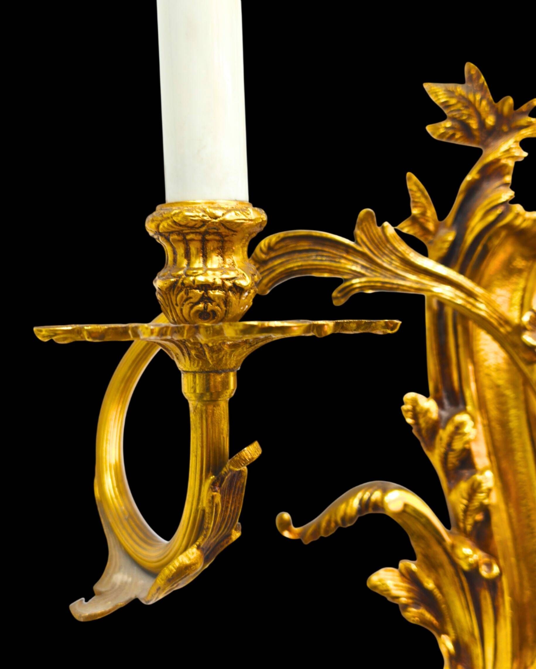 Pair of gilded bronze wall sconces in Rococo style, three lights.