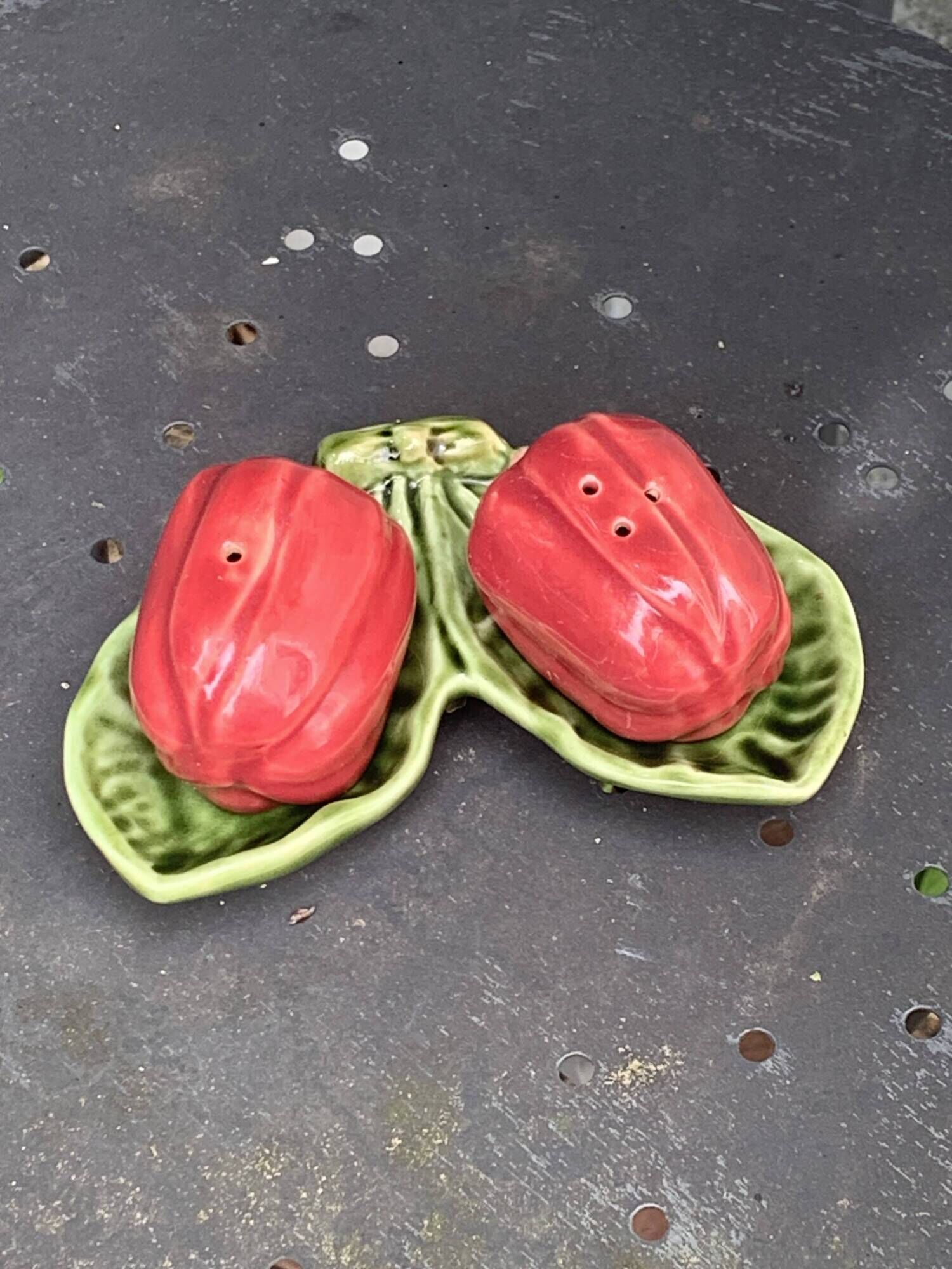 Ceramic salt shakers, slip in the shape of peppers.