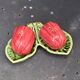 Ceramic salt shakers, slip in the shape of peppers.