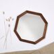 Old second-hand wooden mirror, octagonal shape.