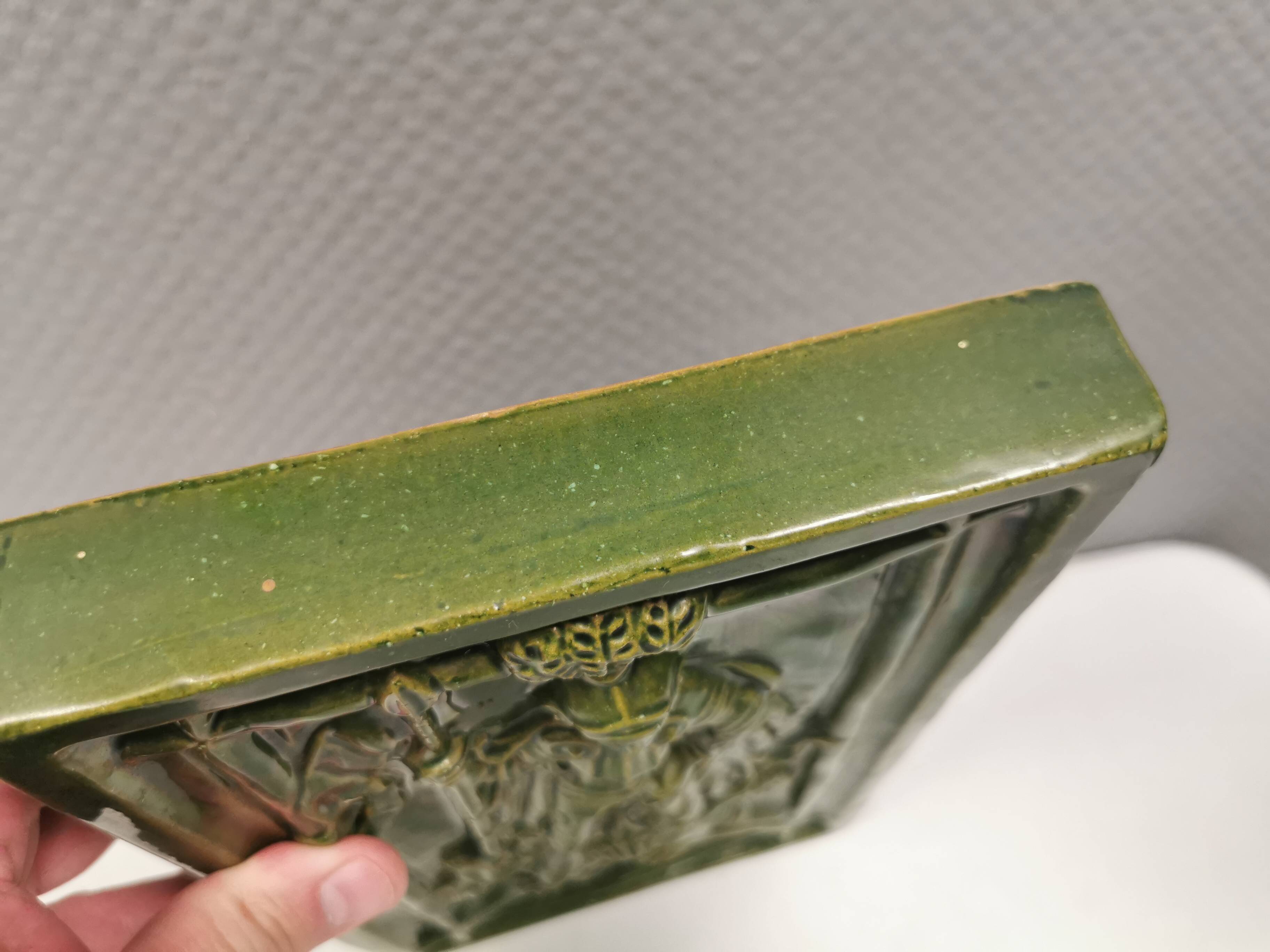 Antique tile in green faience, motif of Saint George and the dragon