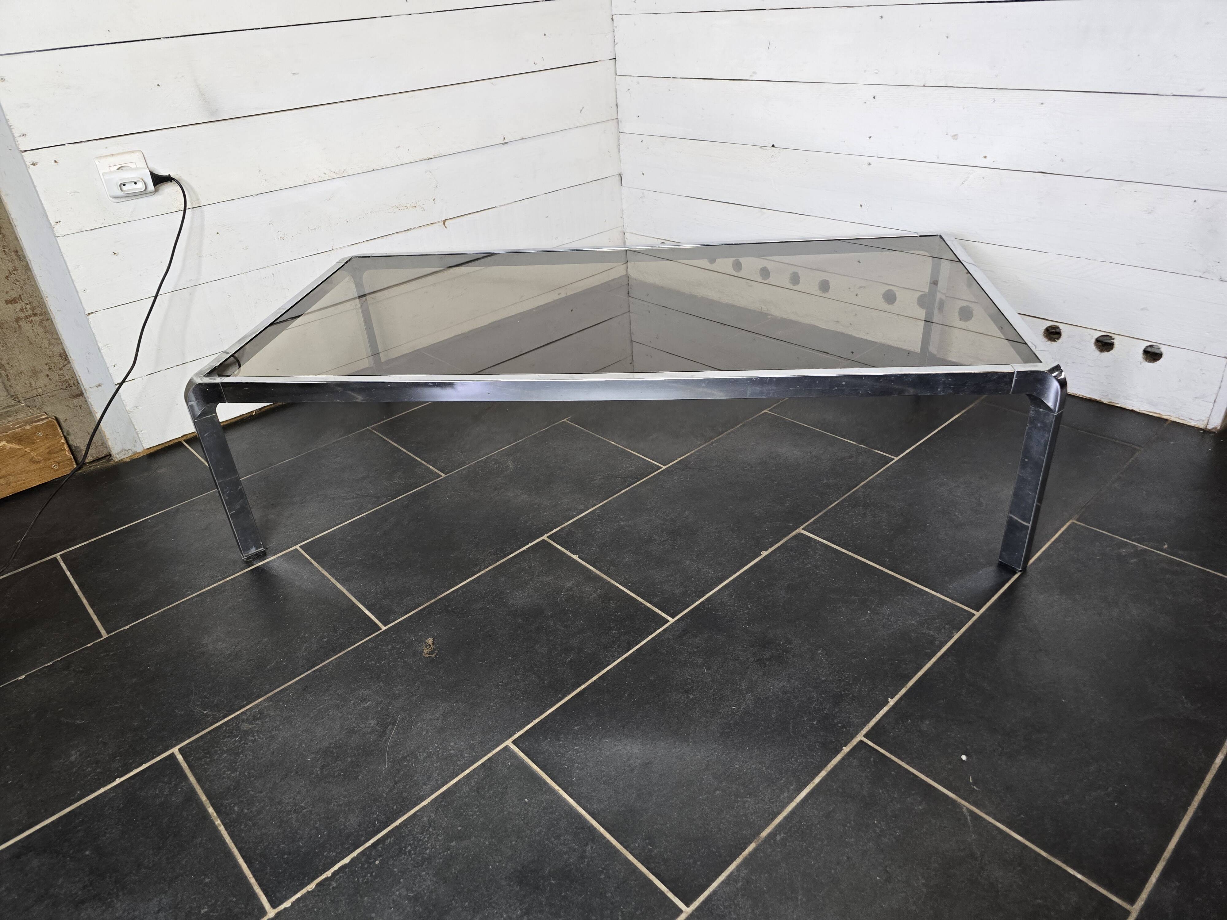 Chromed metal coffee table with smoked glass top from the 70s