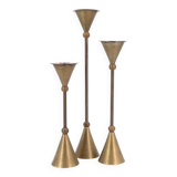 Trio of brass candlesticks by Christian de Beaumont