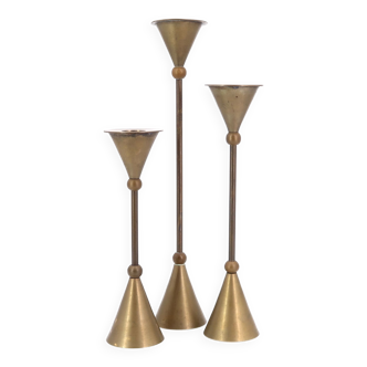 Trio of brass candlesticks by Christian de Beaumont