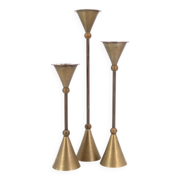 Trio of brass candlesticks by Christian de Beaumont