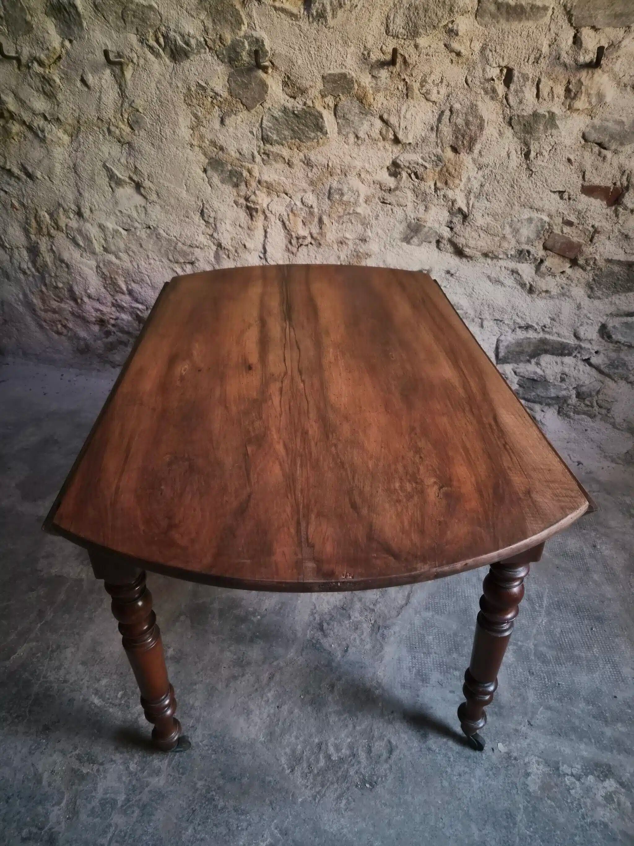 Antique drop-leaf dining table in walnut, France, circa 1900.