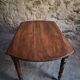 Antique drop-leaf dining table in walnut, France, circa 1900.