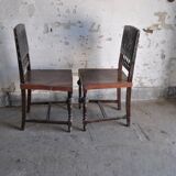 Pair of antique wooden and brown leather dining chairs, brass studs.