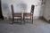 Pair of antique wooden and brown leather dining chairs, brass studs.