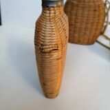 Trio of woven wicker bottles