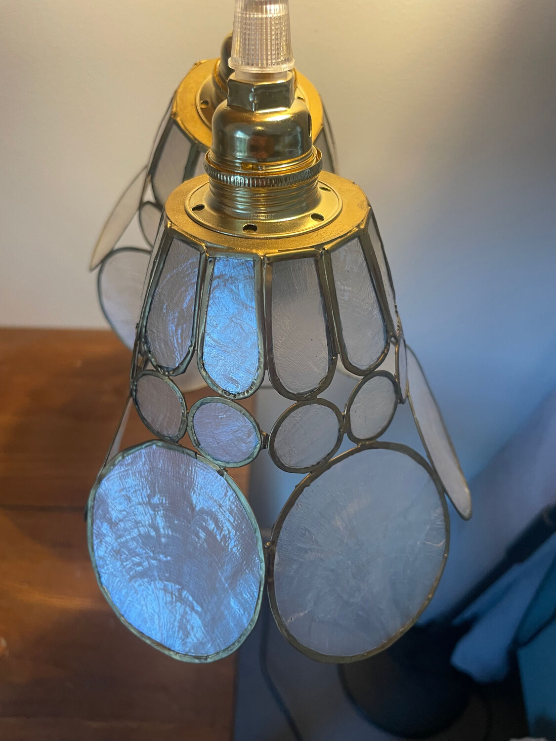 Pair of portable lamps with mother-of-pearl lampshades and brass.