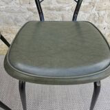 Black metal chairs with khaki faux leather seats, circa 1960.