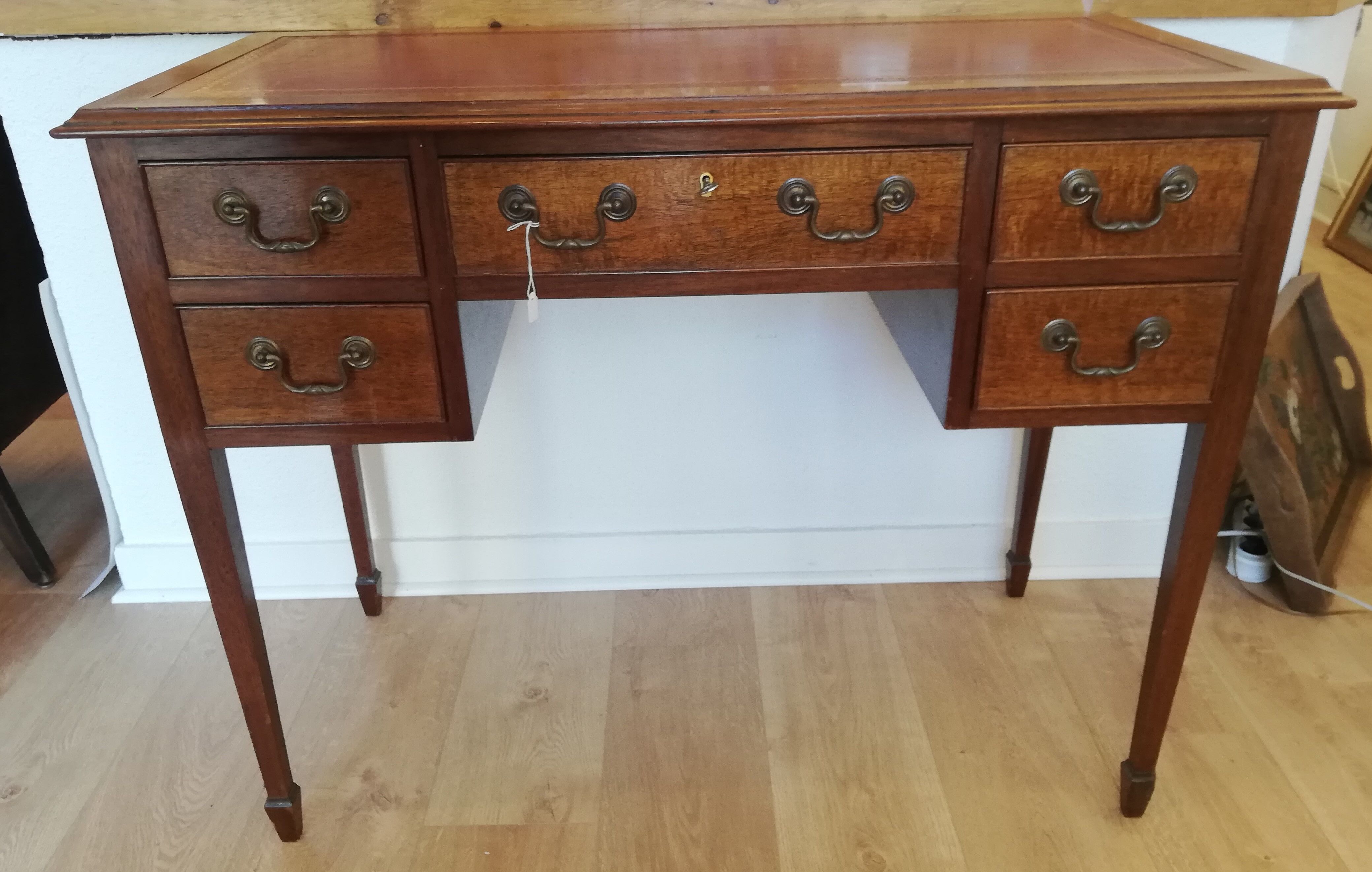 English wooden desk on top of leather
