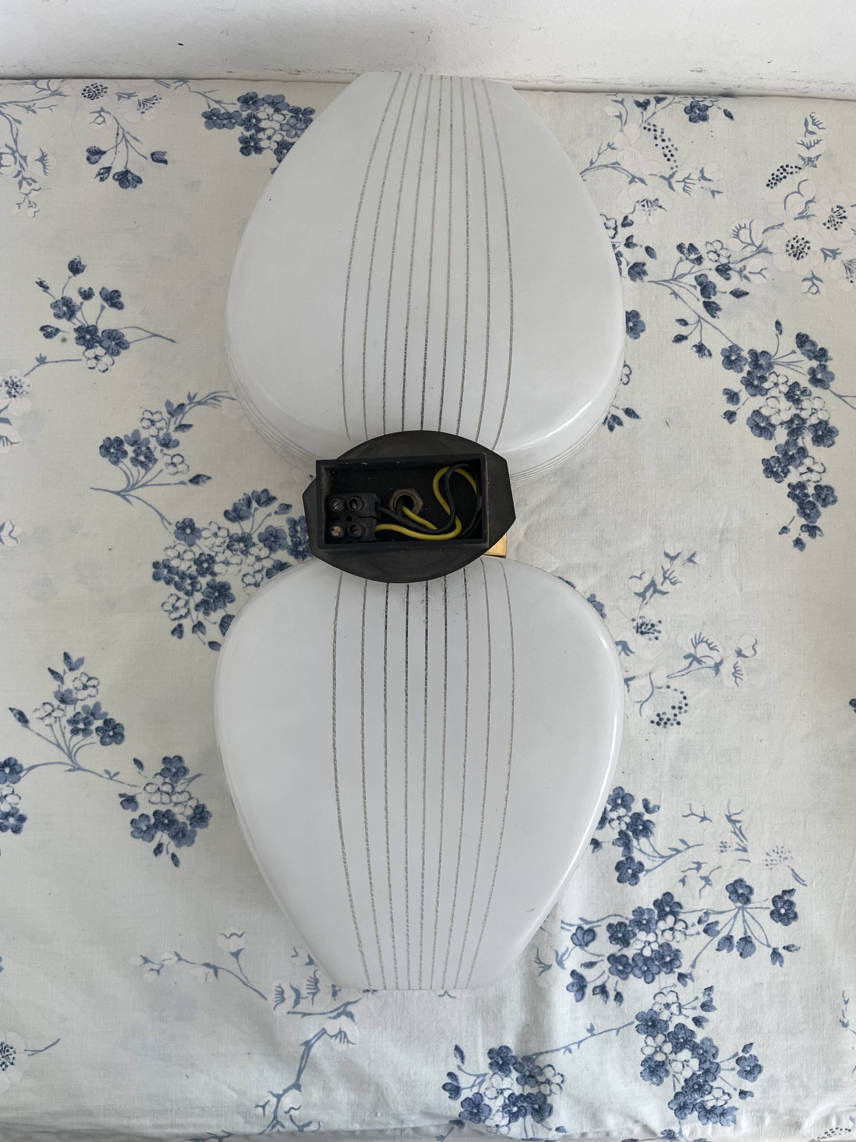 Pair of vintage wall lights from the 60s-70s in striped opaline glass and gilded brass.