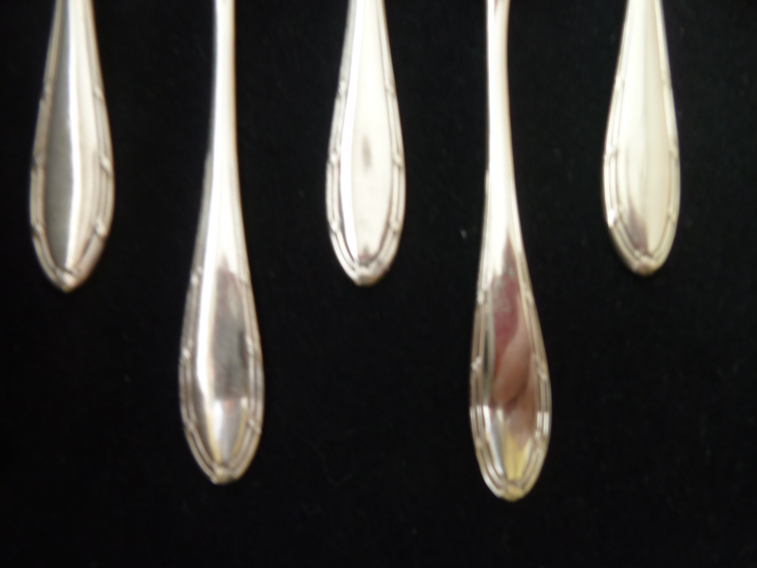 Set of 12 silver metal mocha spoons, crusader ribbon model