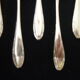 Set of 12 silver metal mocha spoons, crusader ribbon model