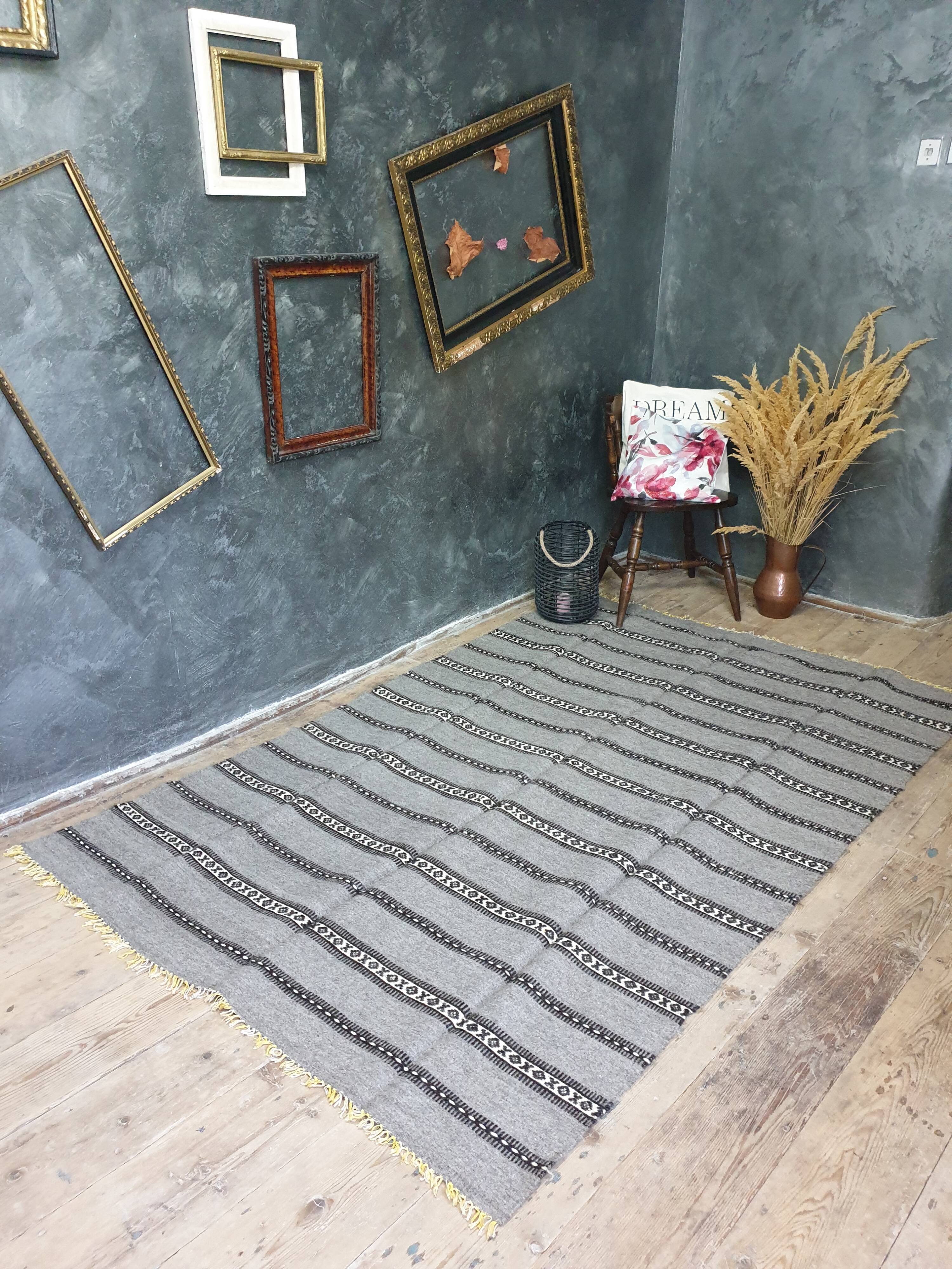 Handwoven vintage geometrical rug, grey background