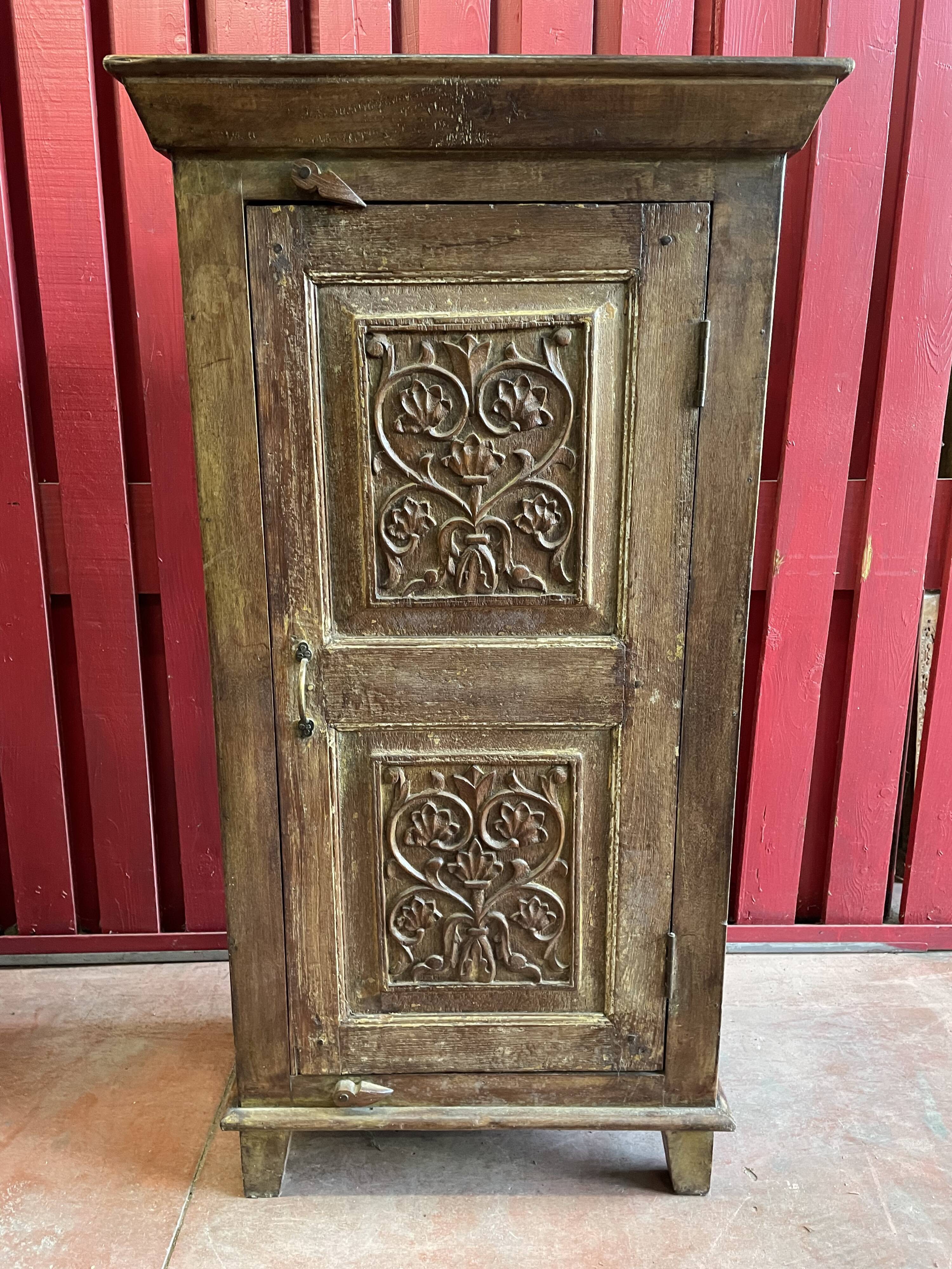India. Bonnetière with a teak door finely carved by hand.