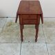Antique small drop-leaf table from the 19th century.