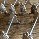 Series of 12 monogrammed silver metal knife holders