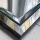 Faceted modernist wall mirror in steel and brass, geometric mixed metal frame 1970s.