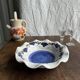Small hand-painted earthenware salad bowl with garland of blue flowers, mark below