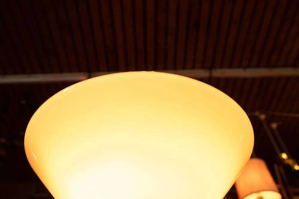 Vintage floor lamp in milky glass and chrome, minimalist uplight lighting.