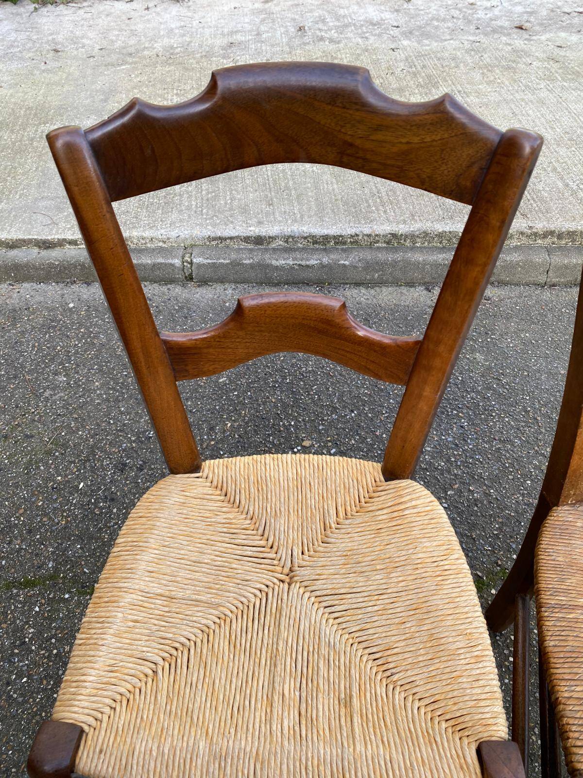 2 solid oak carved and rush-seated chairs in the Louis Philippe style, 19th century.