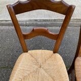 2 solid oak carved and rush-seated chairs in the Louis Philippe style, 19th century.