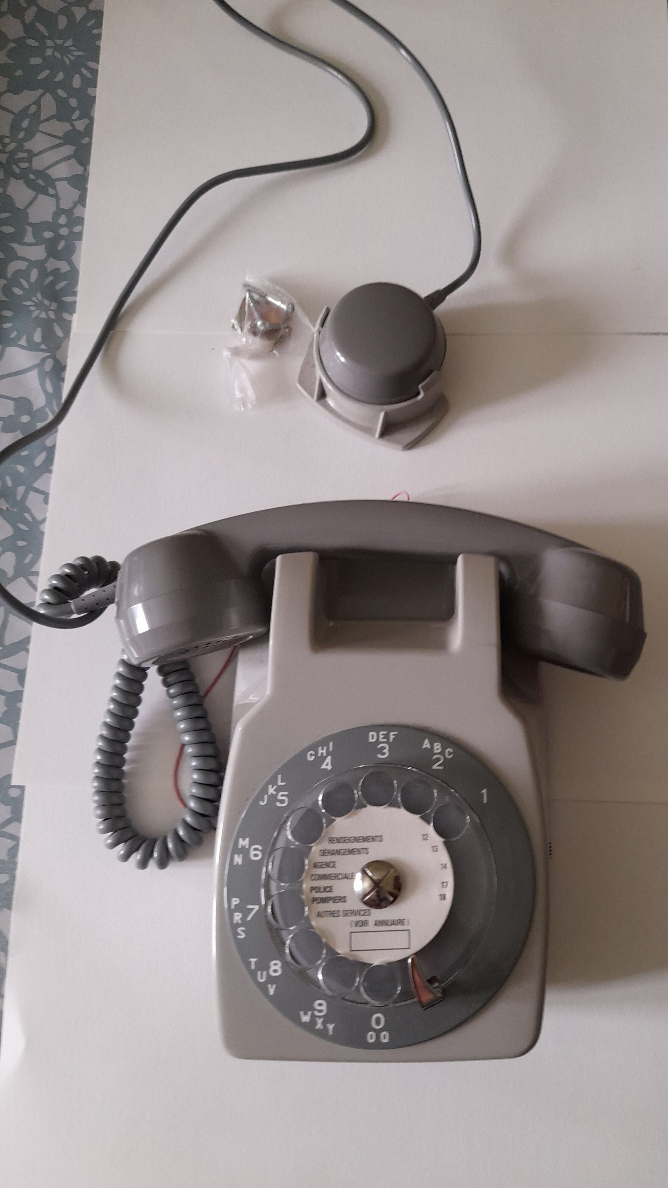 Wall telephone with dial with amplifier