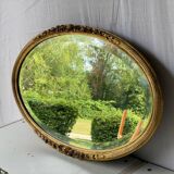 Vintage carved and gilded oval wall mirror