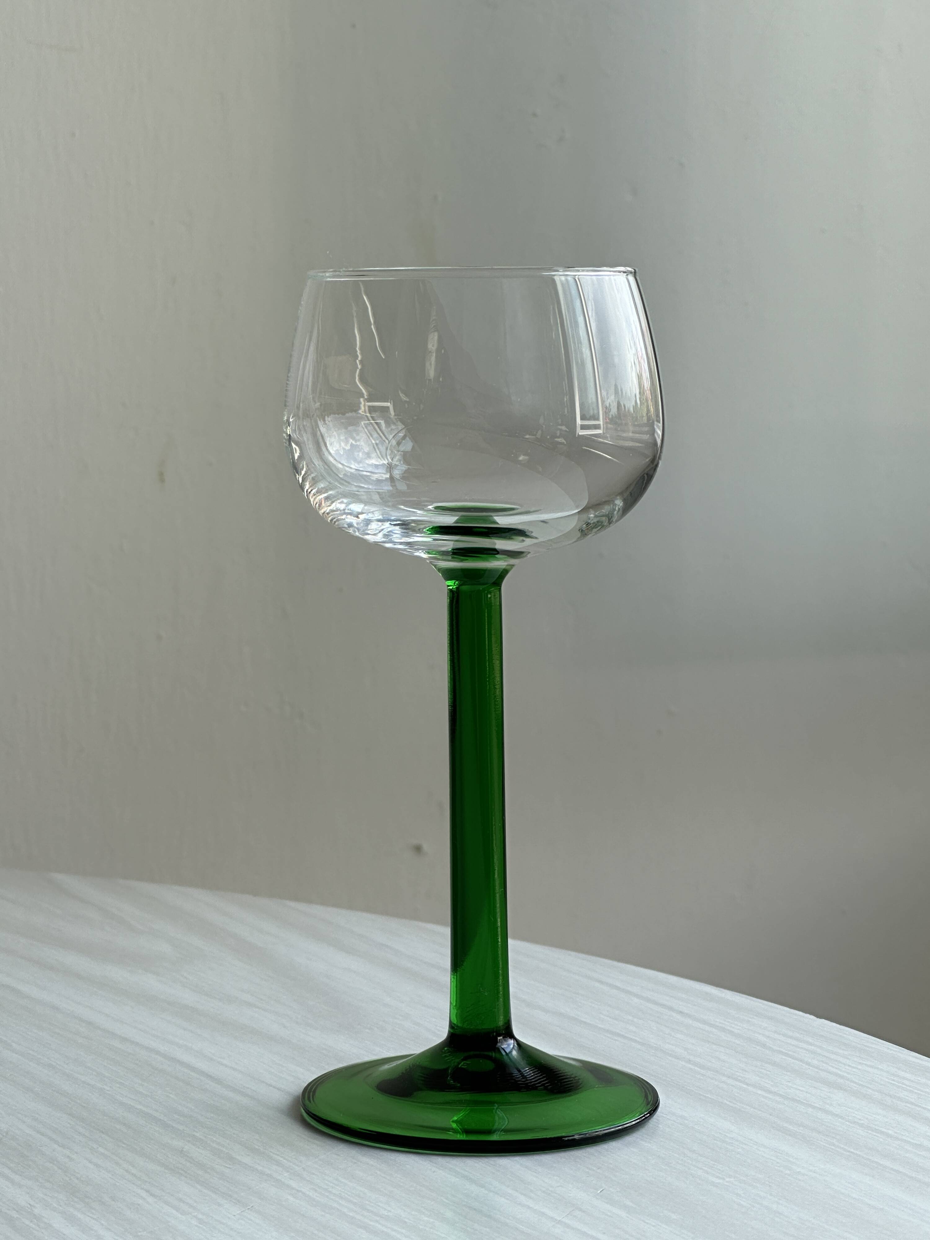 8 Alsatian stemmed glasses, transparent glass and green stems.
