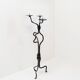 Large wrought iron candelabrum with an abstract design and three candle holders.