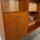 Deens teak vakkenkast met lades en hoge poten, vintage wandkast