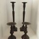 Two pairs of patinated brass candle holders