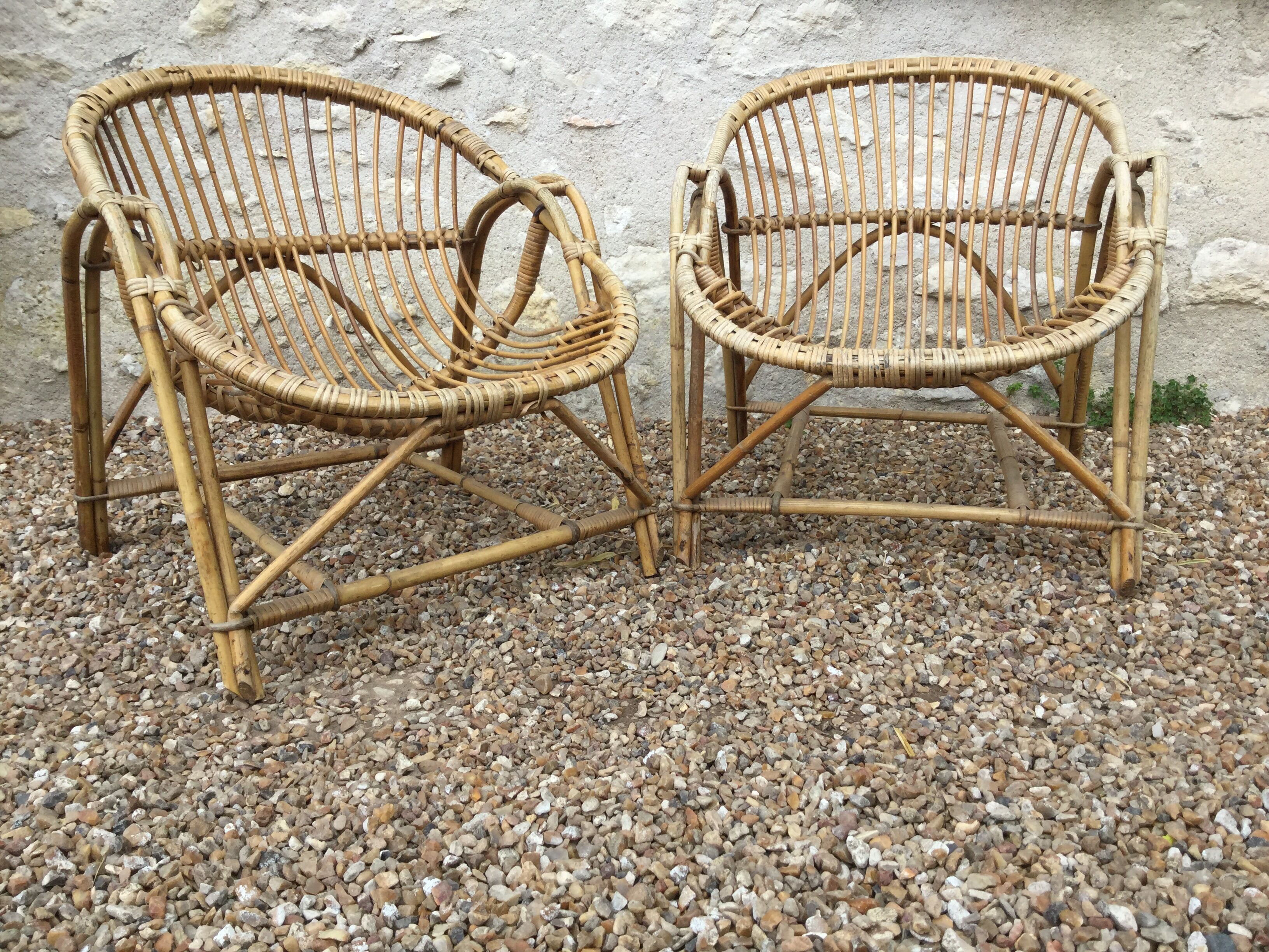 A pair of rattan armchairs