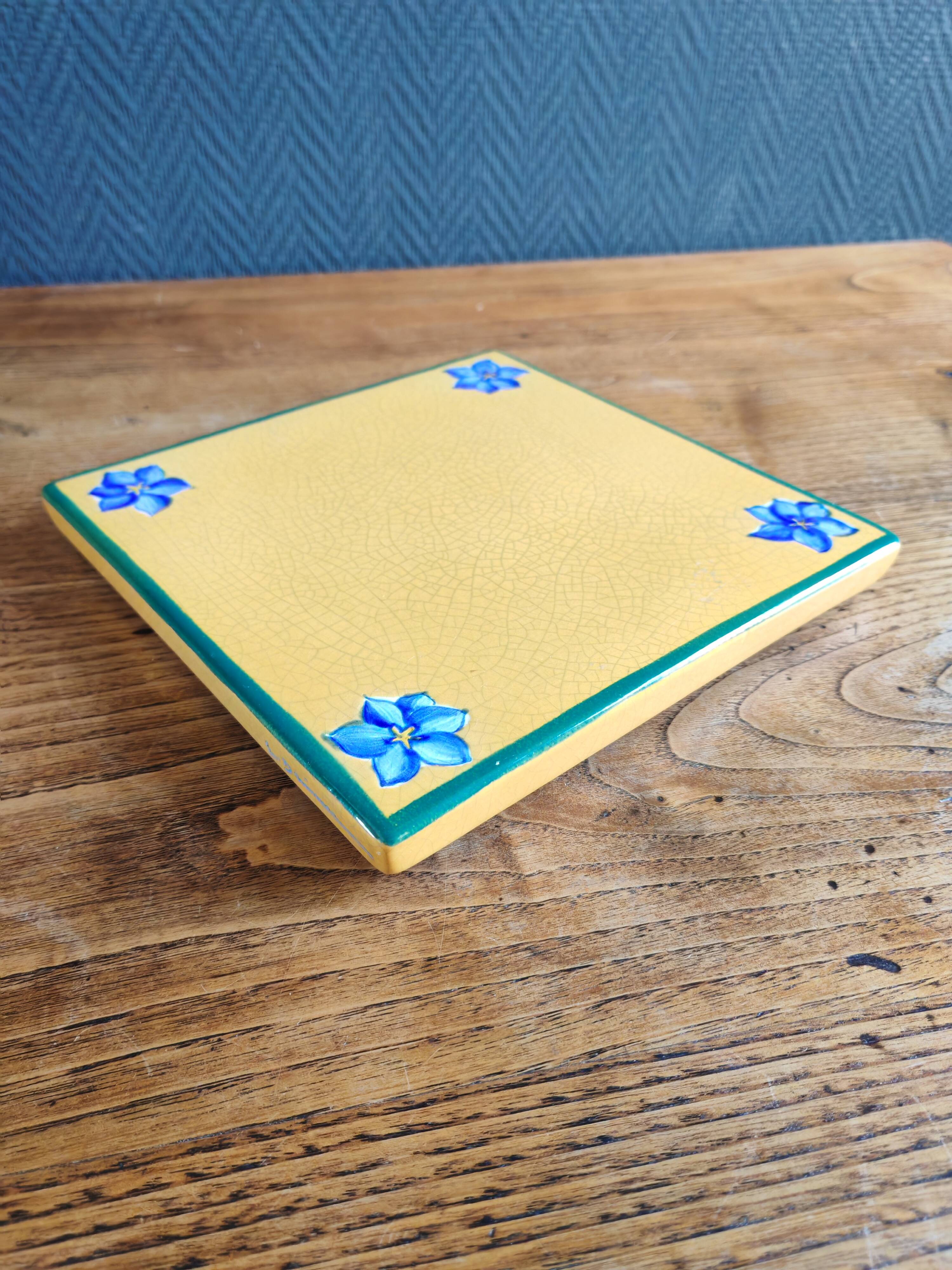 Yellow glazed ceramic trivet signed l. drimmer
