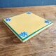 Yellow glazed ceramic trivet signed l. drimmer