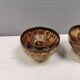 A set of ceramic candle holders in earthy colours.