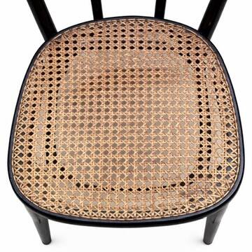 Pair of black curved wooden bistro chairs with caning in Thonet style.