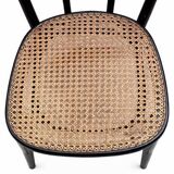 Pair of black curved wooden bistro chairs with caning in Thonet style.