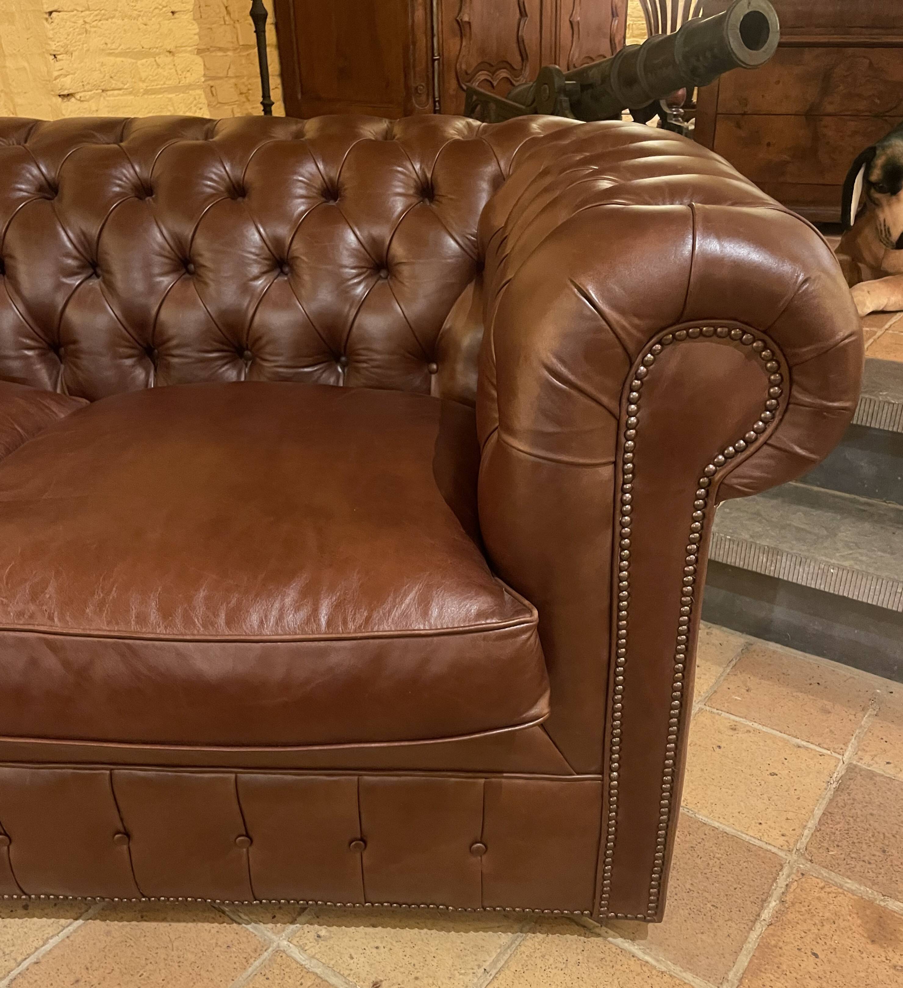 brown leather 2-seater Chesterfield sofa