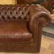 brown leather 2-seater Chesterfield sofa